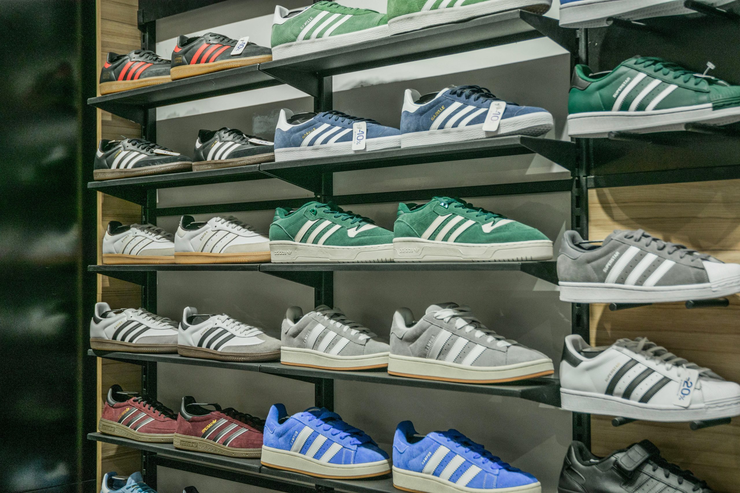 Colorful sneakers arranged on store shelves showcasing trendy footwear options.